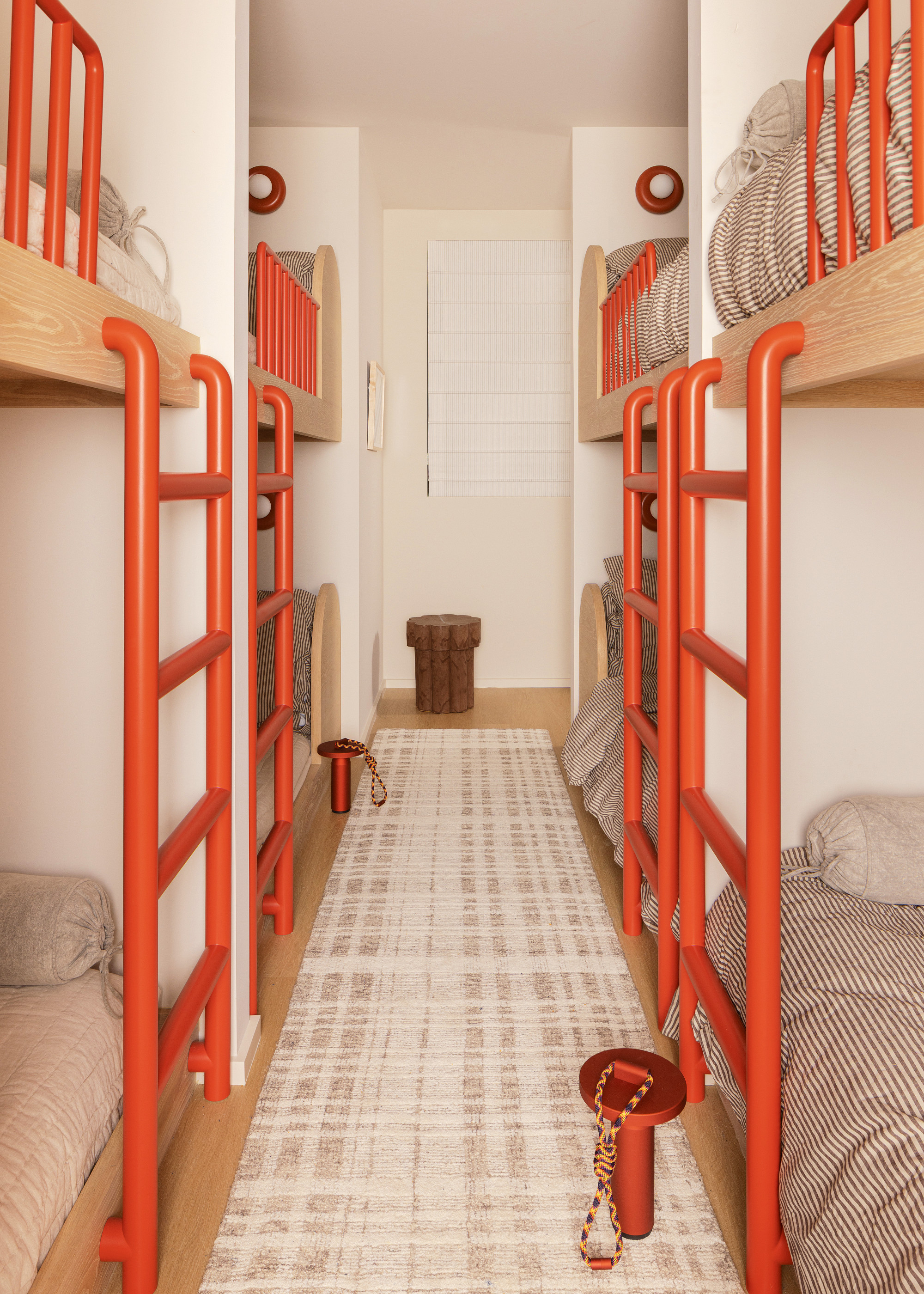 Room of bunk beds with bright orange metalware