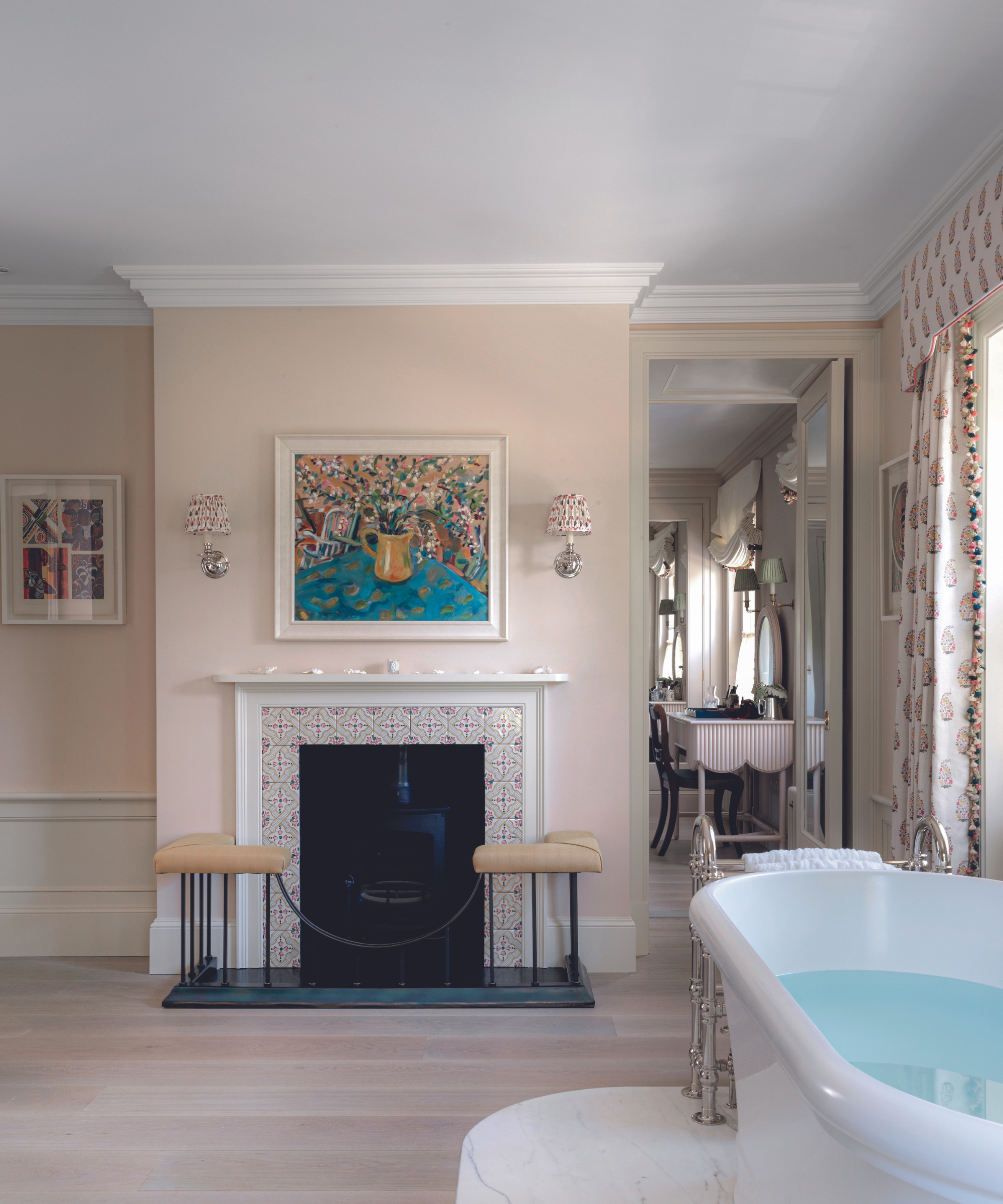 pale pink walls in bathroom with fireplace and freestanding bath