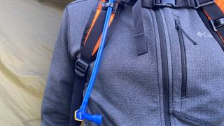 The drinking hose coming out of the right side of the Mission Workshop Hauser 10L hydration pack