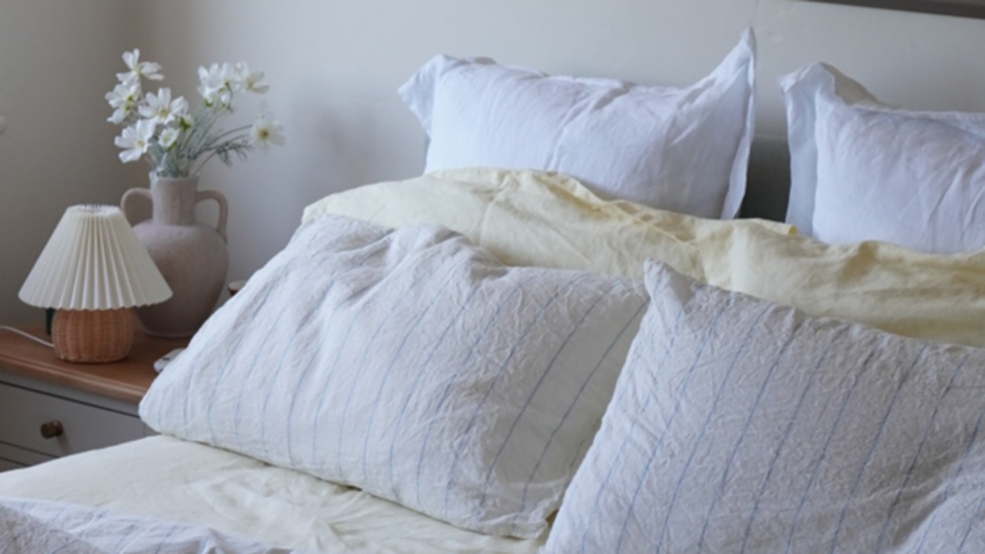 bed with butter yellow sheets and pillows