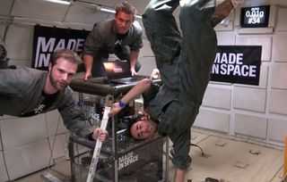 Made in Space team members Adam Ellsworth, Brinson White and Jason Dunn wave to the camera while testing multiple 3D printers in zero-gravity.