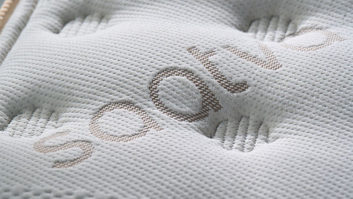 A close up of the Saatva Classic mattress cover, showing the hand tufted finish and stitched details