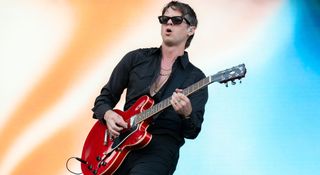 Mark Foster wears wayfarer sunglasses and a black shirt as he plays a Cherry Gibson ES-355 during Foster the People's set at Austin City Limits, October 2024.