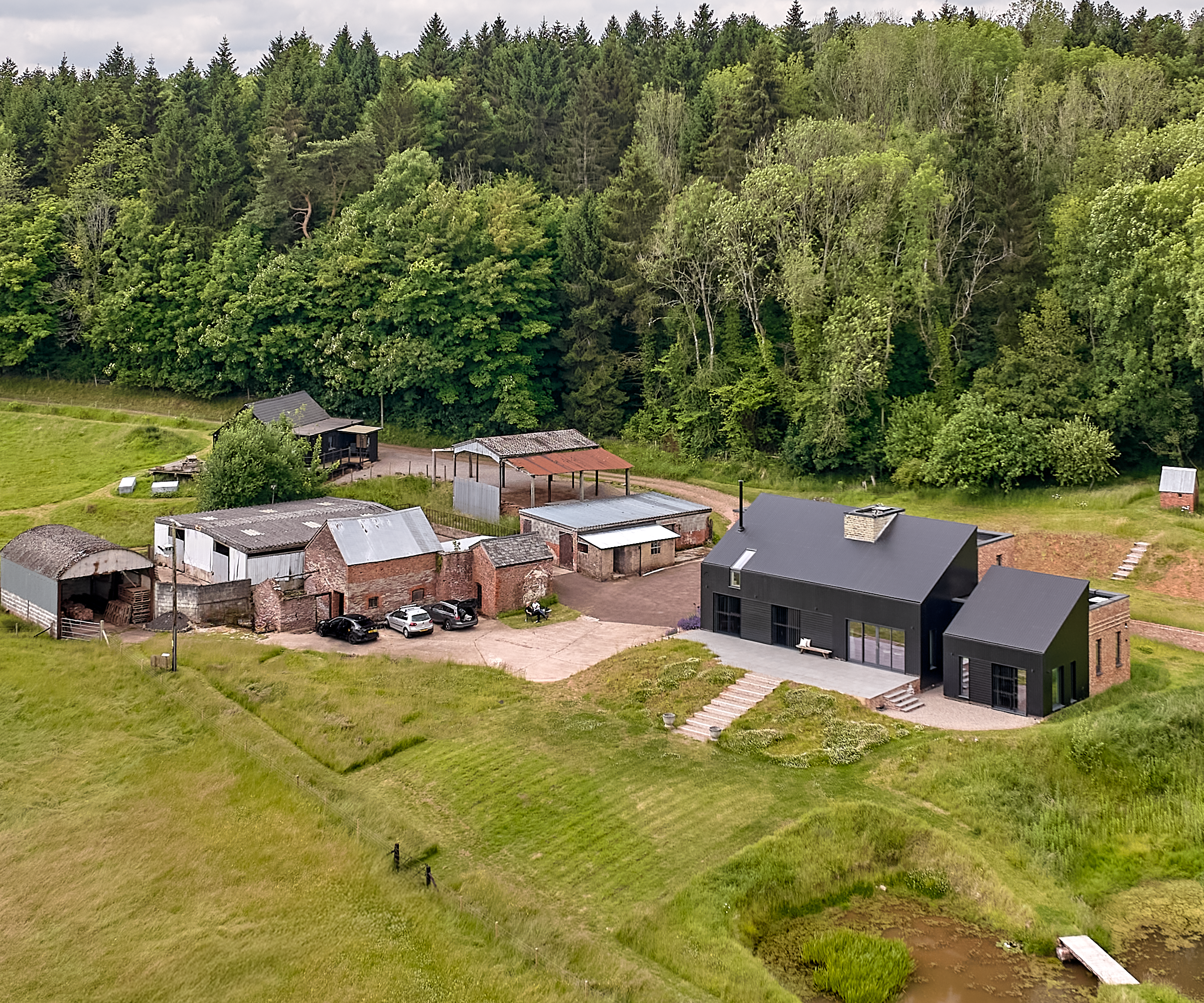Birds eye view of the property, land and woods