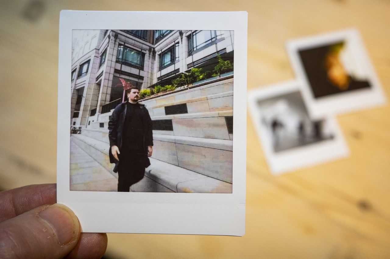 Fujifilm Instax Pal print of a street scene, on Link Square film,, in the hand