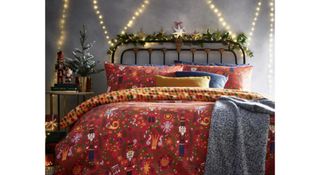 A red bedding set from Furn. with nutcracker graphics.