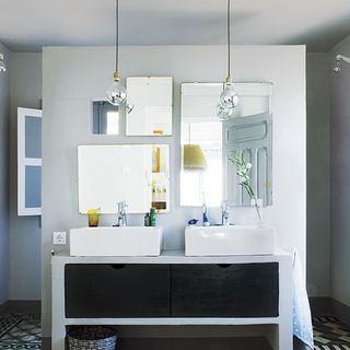 bathroom with white double sink and lamps