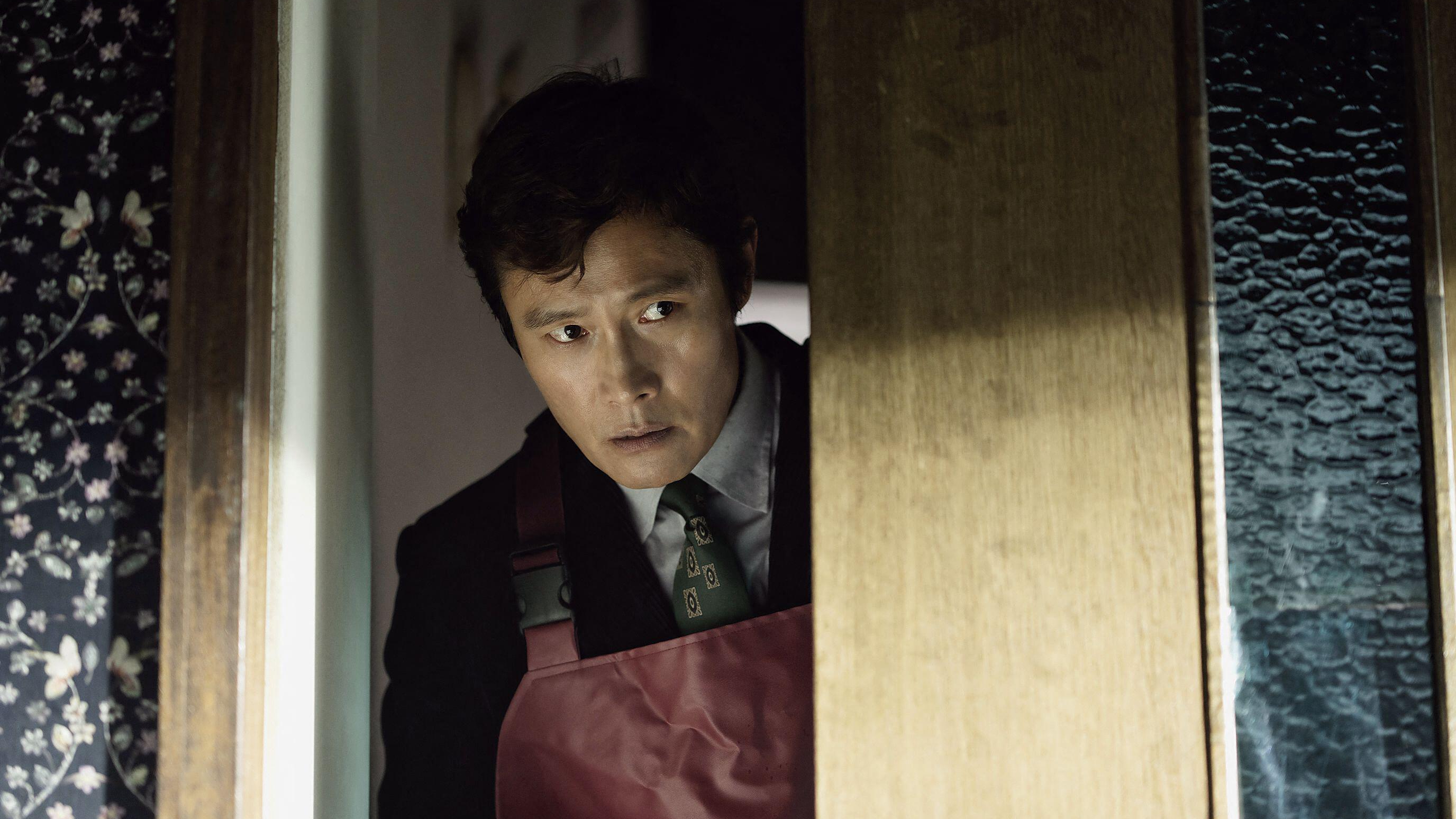 Man-su (Lee Byung-hun) peers round a corner in a scene from Park Chan-wook's &amp;quot;No Other Choice&amp;quot;