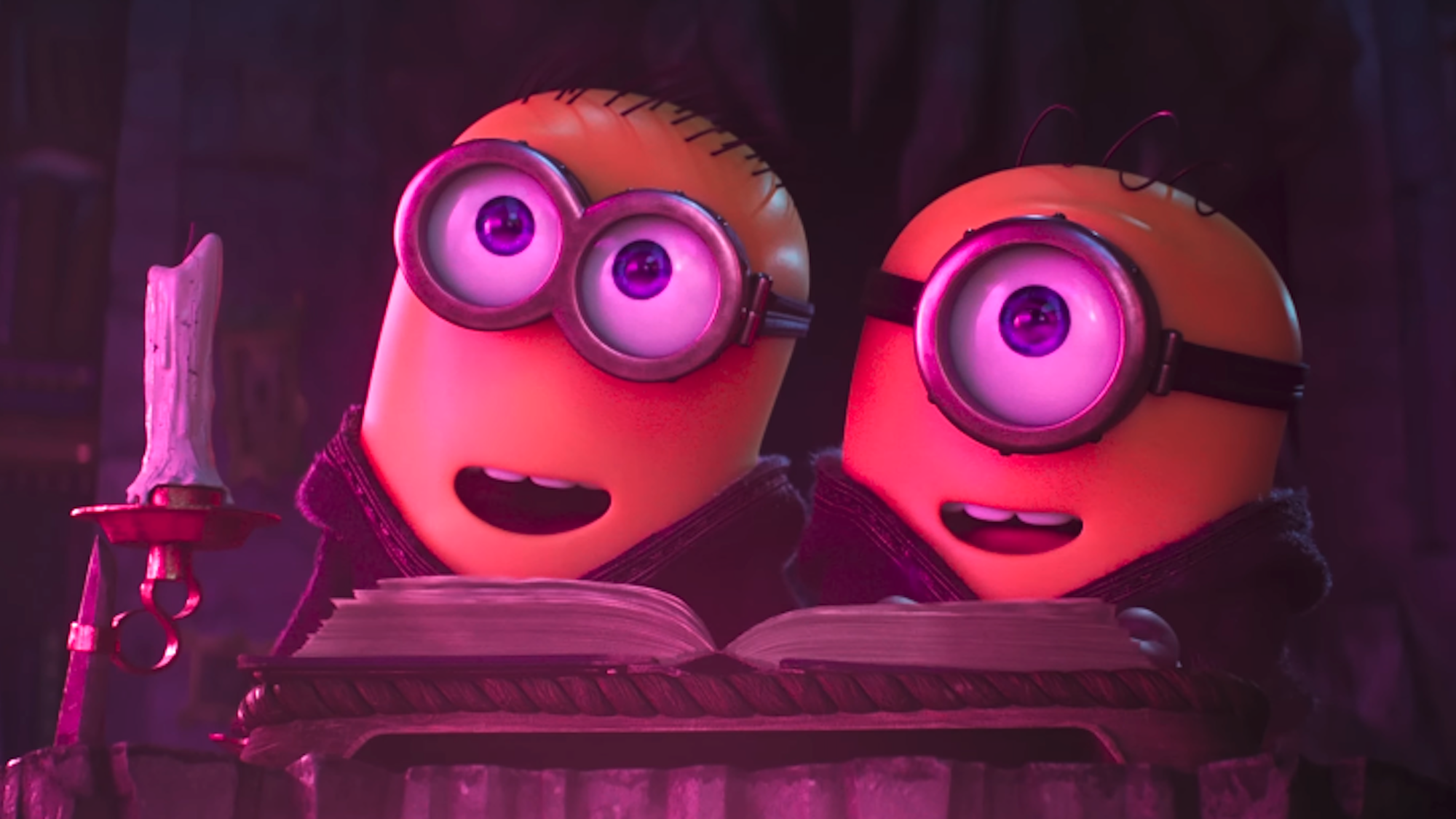 two minions smiling with a pink light on them