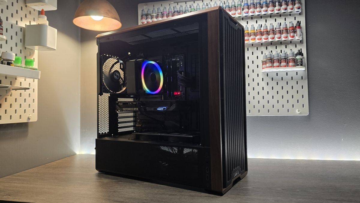 A Lian Li Lancool 217 on a desk with various components installed inside it.