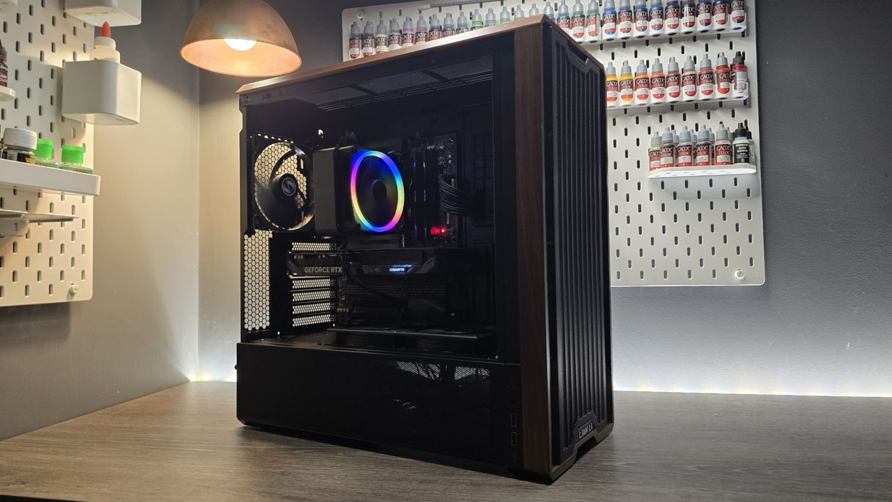 A Lian Li Lancool 217 on a desk with various components installed inside it.