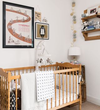 neutral nursery with wooden cot