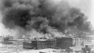 Buildings on fire in Tulsa, Oklahoma during the 1921 Tulsa race massacre 