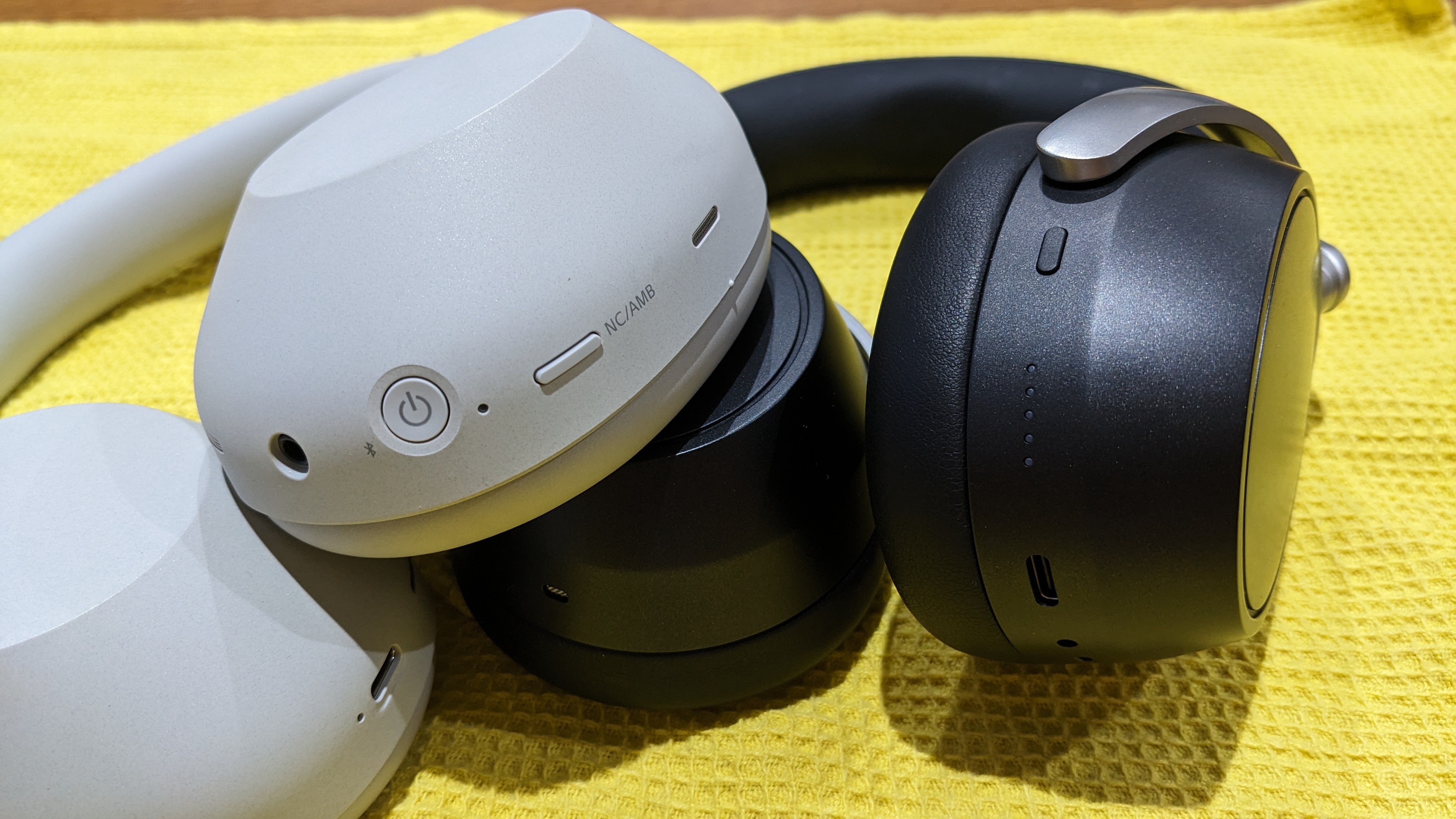 Close-up of the Sennheiser HDB 630 and Sony XM6 earcup controls