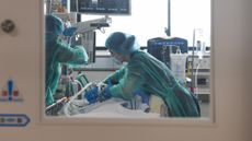 Medics treat a patient in the intensive care unit at Chiba University Hospital in Japan