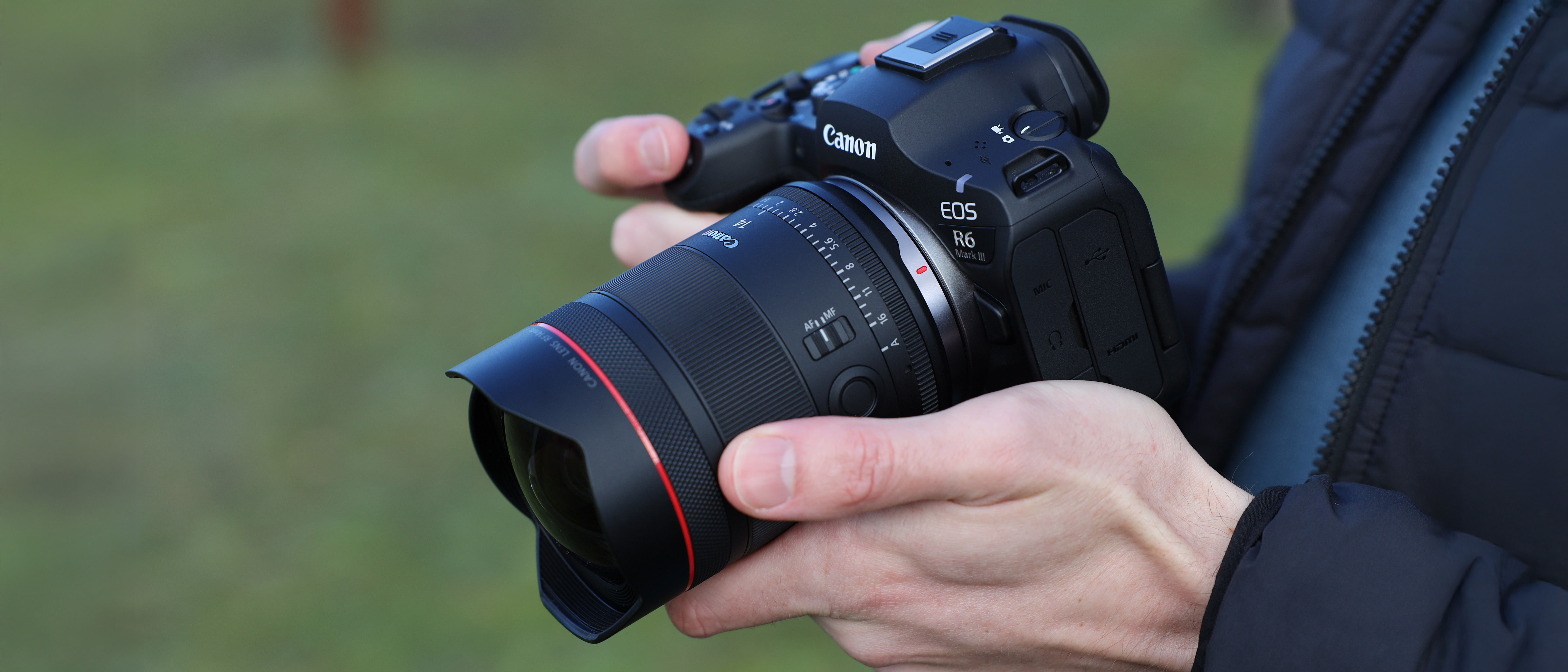 Canon EOS R6 Mark III camera with Canon RF 14mm f/1.4L VCM lens attached held in a pair of hands
