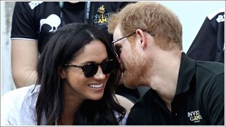 Meghan Markle wearing tortoiseshell sunglasses with Prince Harry leaning in to talk in her ear / during the Invictus Games 2017 at Nathan Philips Square on September 25, 2017 in Toronto, Canada