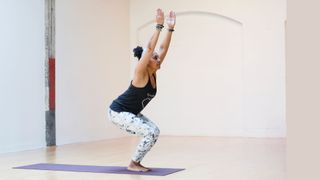 Woman doing chair pose in yoga as a workout