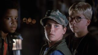 Joaquin Phoenix in a camo hat, standing next to Peter Billingsley in Russkies. 