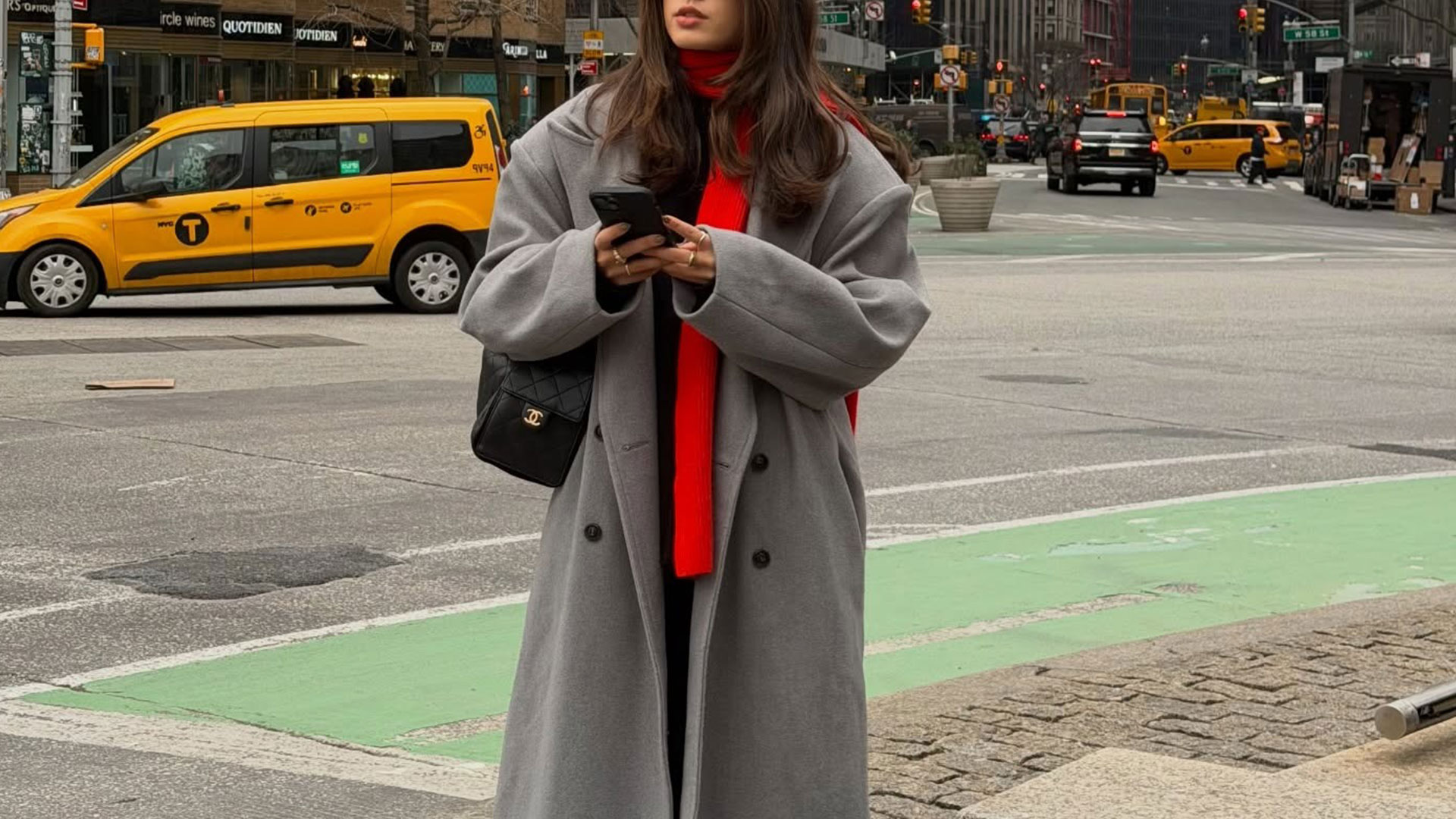 @tia_dewitt nyc winter outfit, grey long coat with a red scarf and chanel 25 bag