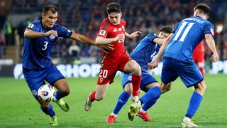 Wales' Daniel James attempts to win the ball from Kazakhstan's Nuraly Alip during the March 2025 World Cup qualifier.