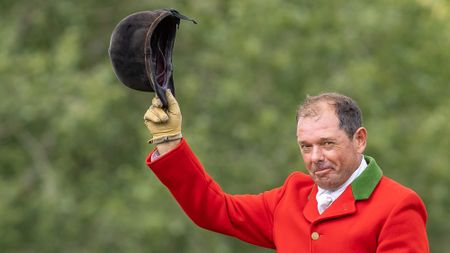 Robert Walker raises his hunt cap after winning the Alan Marnie Meta Lounge Ltd SHB(GB) Supreme Hunter Championship at The Agria Royal International Horse Show with Full Cry on 23 July 2026
