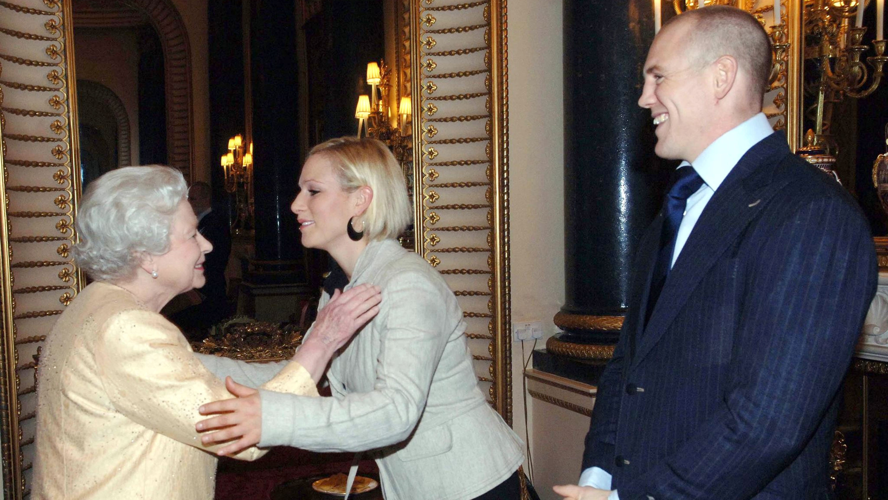 Queen Elizabeth greets her granddaughter, Zara, and Mike Tindall at a Buckingham Palace reception for the country's top achievers on December 19, 2006