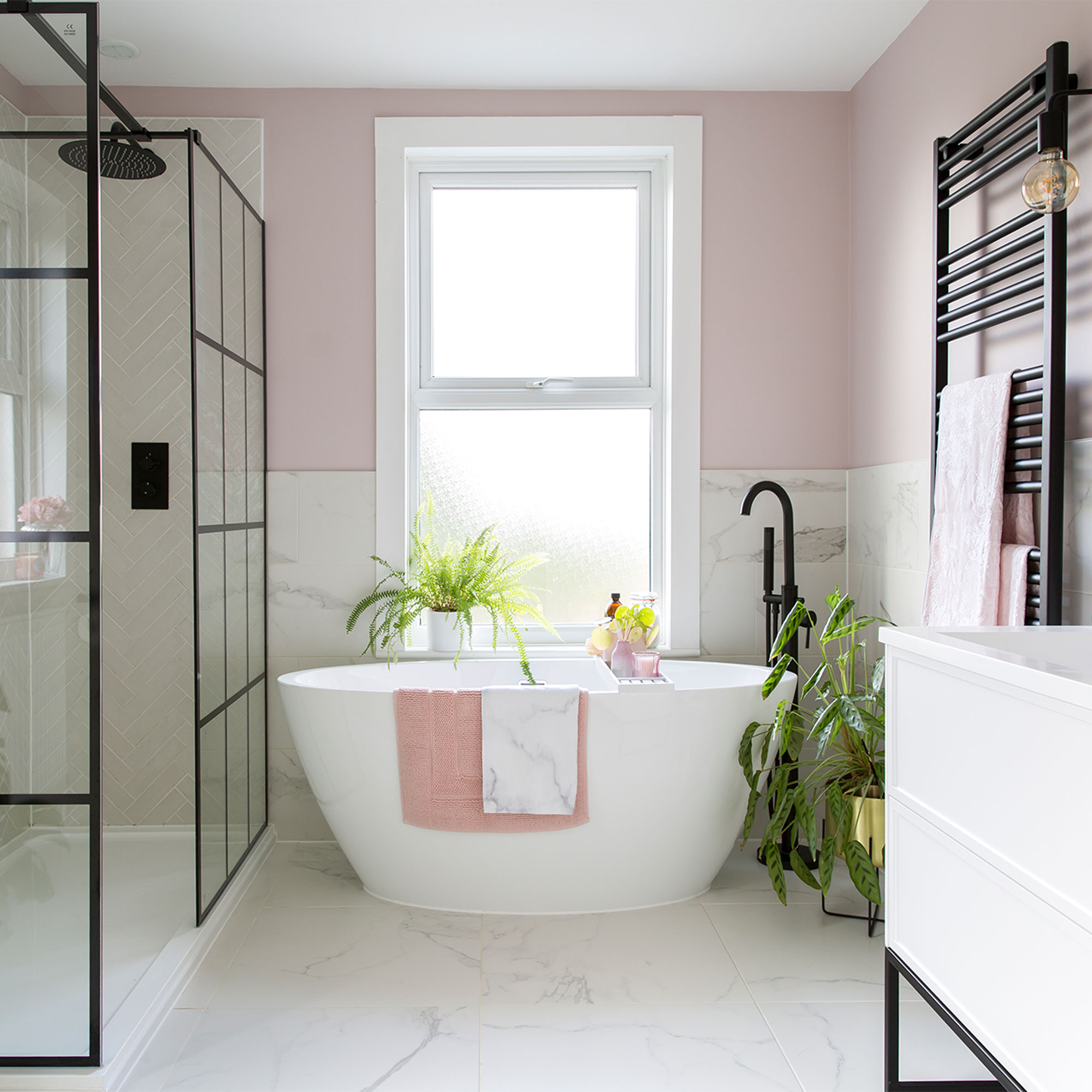 Pink bathroom with walk in shower and freestanding bath