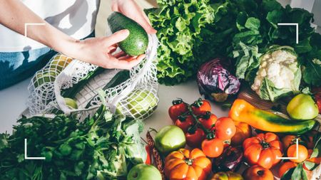 Selection of vegetables on the table in the sunlight, including avocado, tomatoes, peppers, cauliflower and some of the foods for seasonal affective disorder