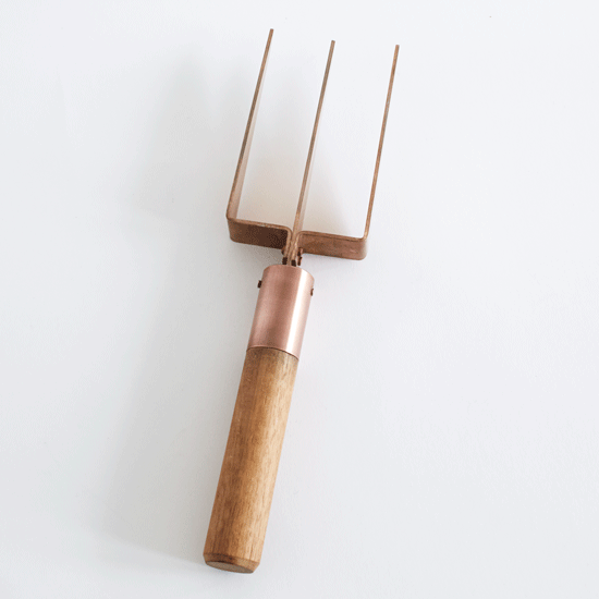 wooden garden fork with white background