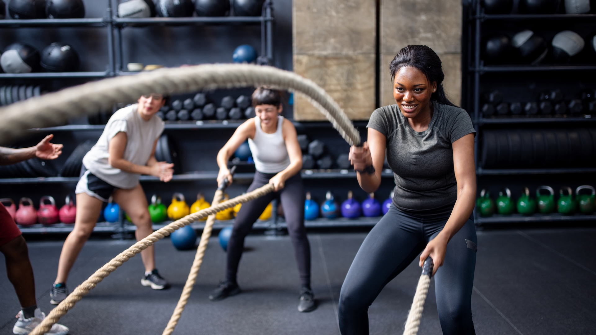Woman using the battle ropes in a gym