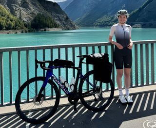 Amy Hudson lakeside with a Pinarello bike