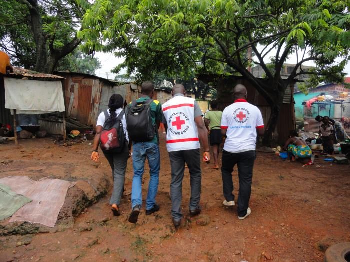 Guinean Red Cross volunteers making their way door-to-door, sharing information about Ebola during the 2014 outbreak.