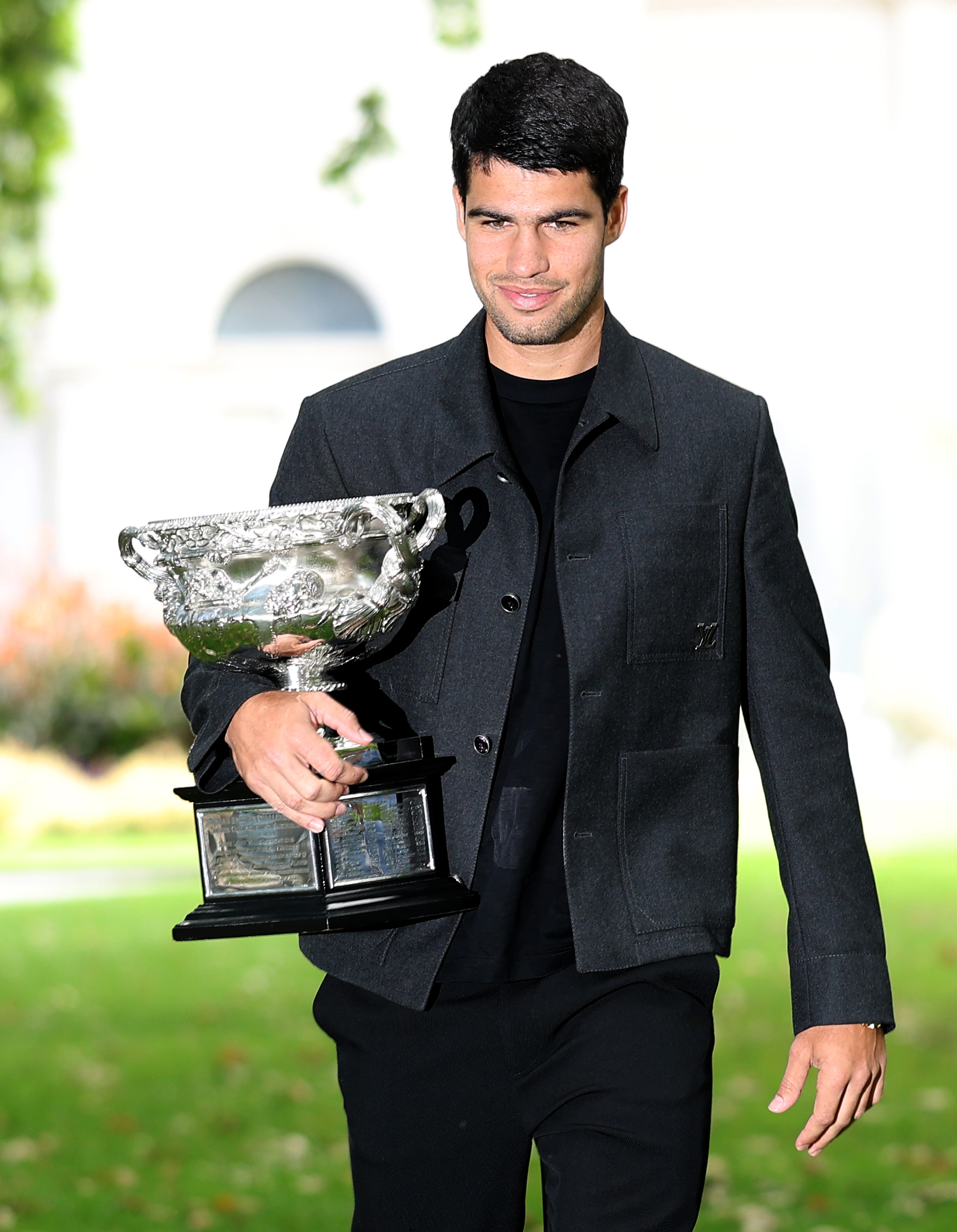 MELBOURNE, AUSTRALIA - FEBRUARY 02: Carlos Alcaraz of Spain poses with the Norman Brookes Challenge Cup during the 2026 Australian Open Men's champion media opportunity at the Royal Exhibition Building on February 02, 2026 in Melbourne, Australia. Alcaraz defeated Novak Djokovic of Serbia in last night's Men's Singles Final.