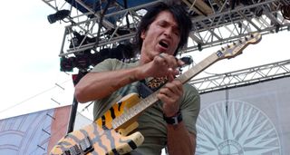 George Lynch goes two-handed on his tiger-striped signature ESP.