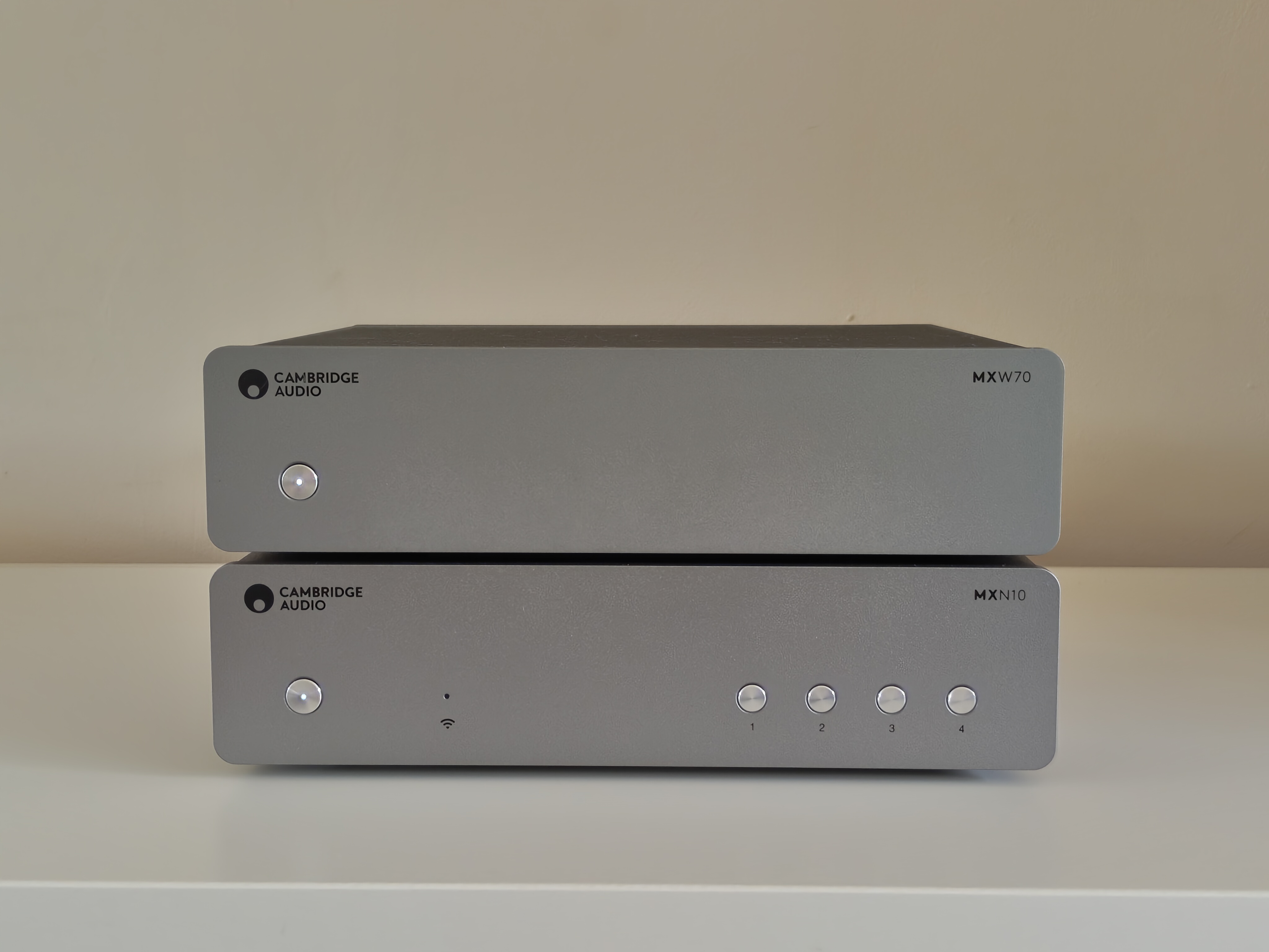 Cambridge Audio MXW70 power amp on book shelf with streamer