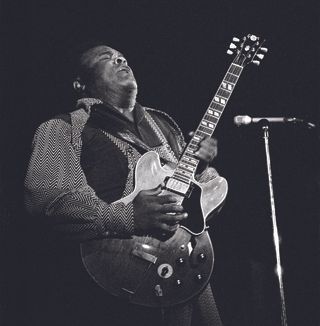 Freddie King performs onstage, playing Gibson ES-345 guitar.