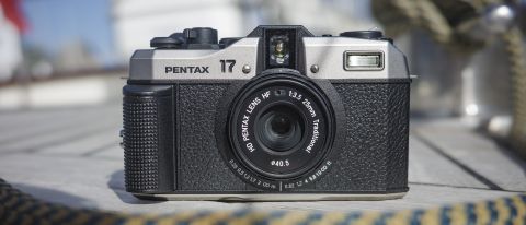 Pentax 17 film camera on the wooden deck of a boat