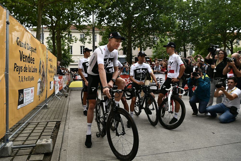 Chris Froone and teammates get ready to go on stage at the 2018 Tour de France team presentation
