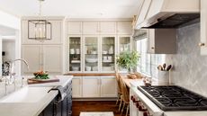 A traditional kitchen with oven, kitchen dresser, and kitchen island