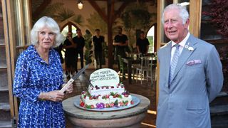 Queen Camilla and King Charles cutting a cake