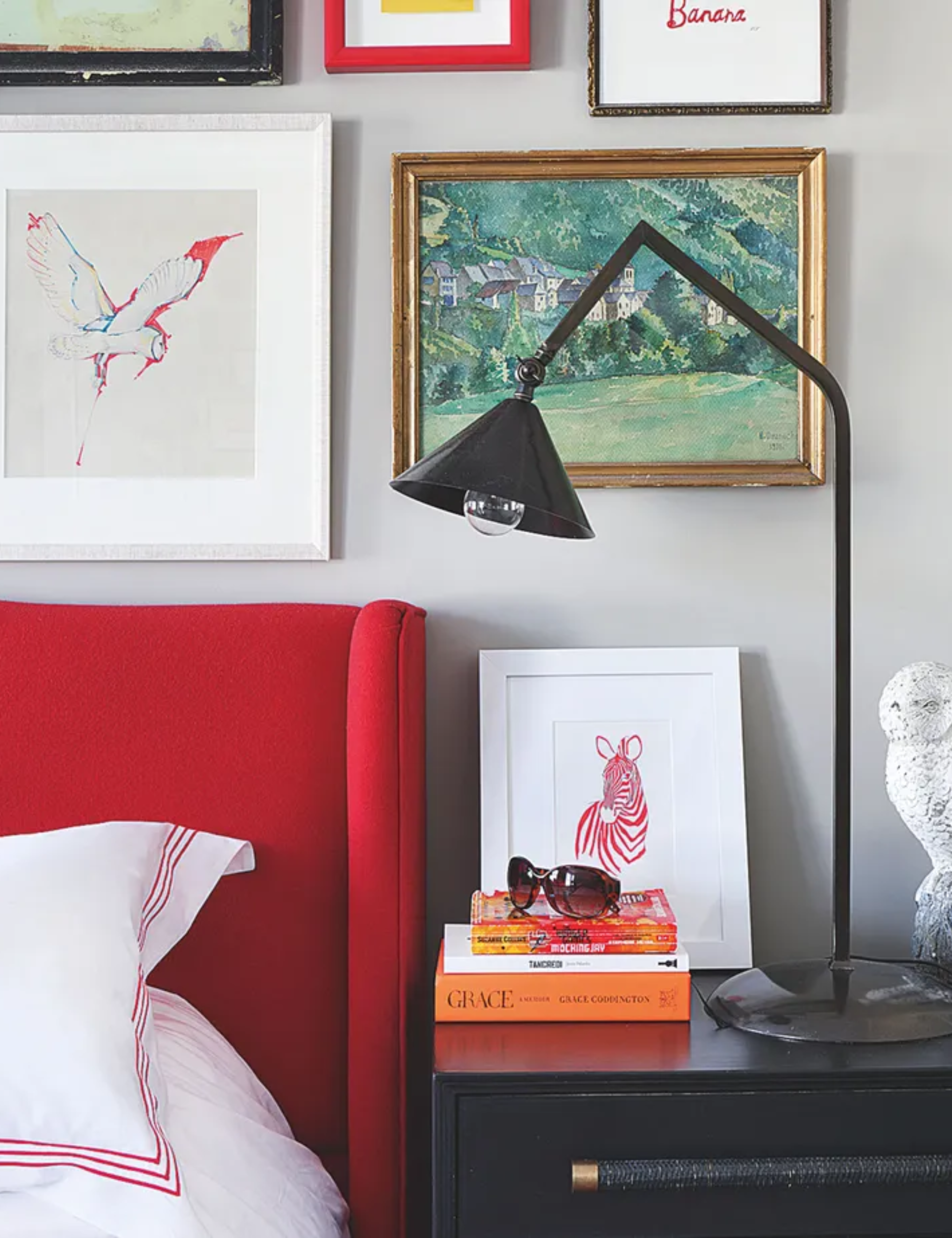 Industrial bedroom with red headboard and black lamp