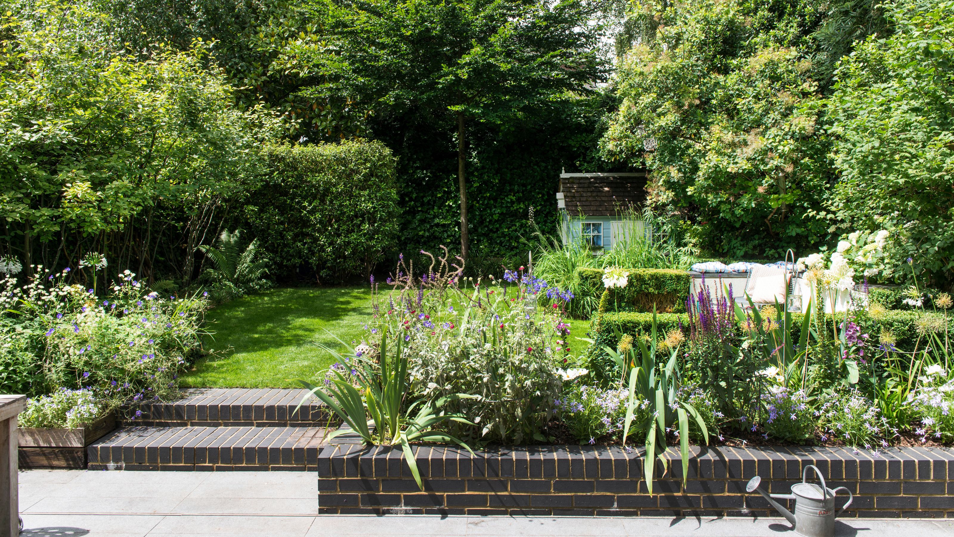 Flower bed border between patio and lawn