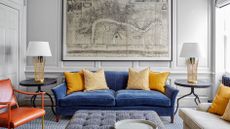 Living room seating ideas with blue sofa and grey wall