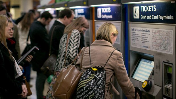 People queue to buy train tickets in Waterloo Train Station