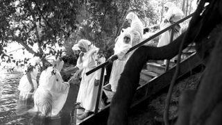 Modern-day Mandaeans participate in a baptism ceremony in Australia. Around 50,000 people practice the Mandaean religion today. The recently deciphered magical amulet sheds light on their ancient ancestors.