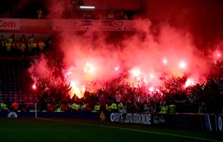 Legia fans set off flares in the stands