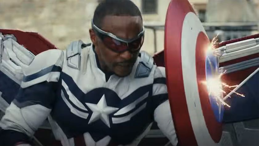 Sam Wilson, new Captain America in full suit and holding his shield as ammo rains down upon him in Brave New World.