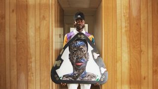 Artist Amoako Boafo with one of the portraits flying on top of the New Shepard crew capsule on the NS-17 mission, which is scheduled to launch on Aug. 25, 2021..