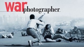 Man photographs scene of armed conflict